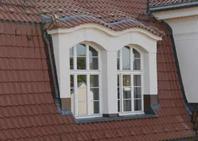 Fledermausgaube mit runder Ziegelf&uuml;hrung und handwerklich angepassten Anschl&uuml;ssen
