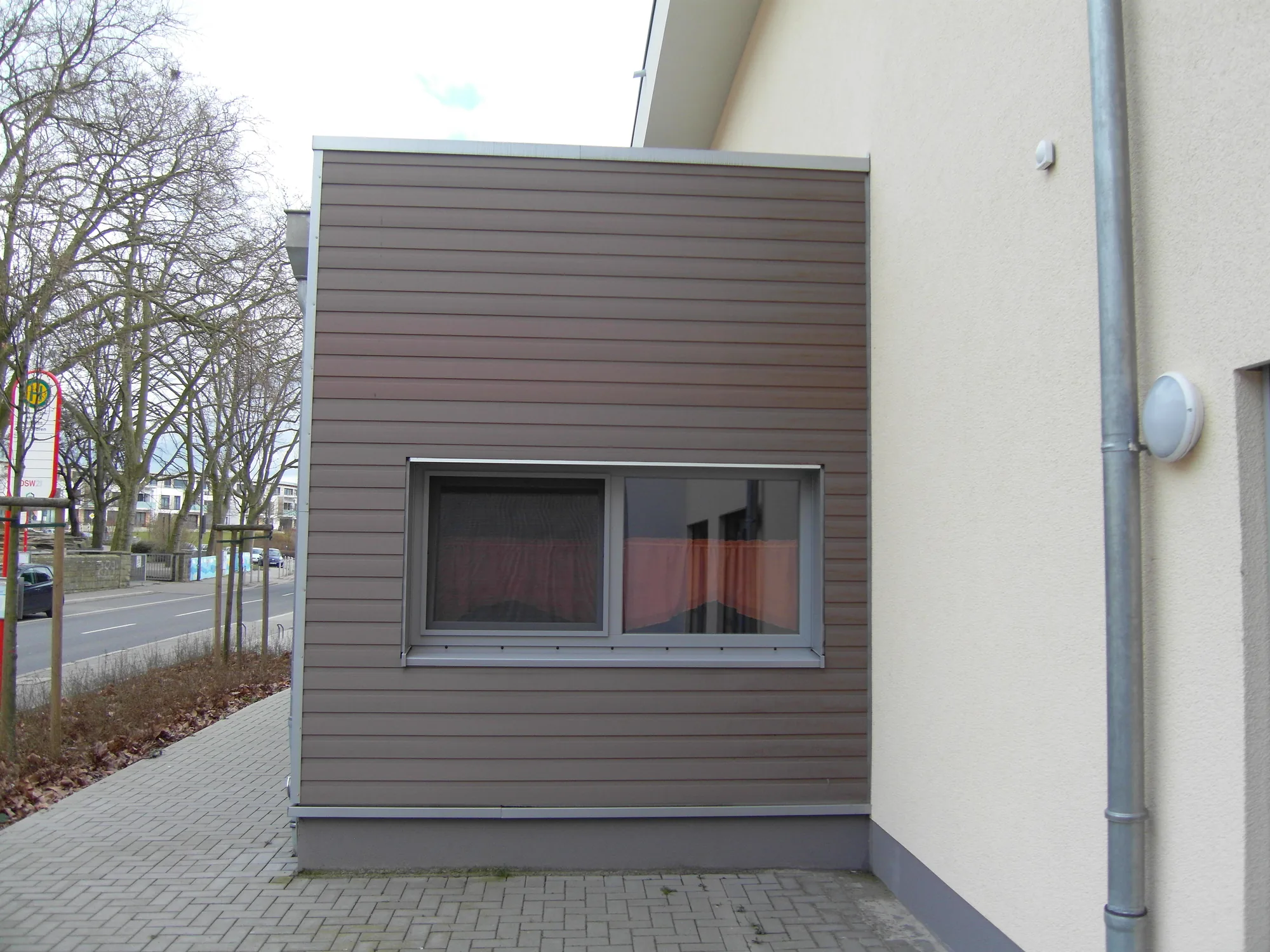 Seitliche Ansicht des Kita-Anbaus in Dortmund mit Fensteranschluss und WPC-Bekleidung Seitliche Ansicht des Kita-Anbaus in Dortmund mit Fensteranschluss und WPC-Bekleidung