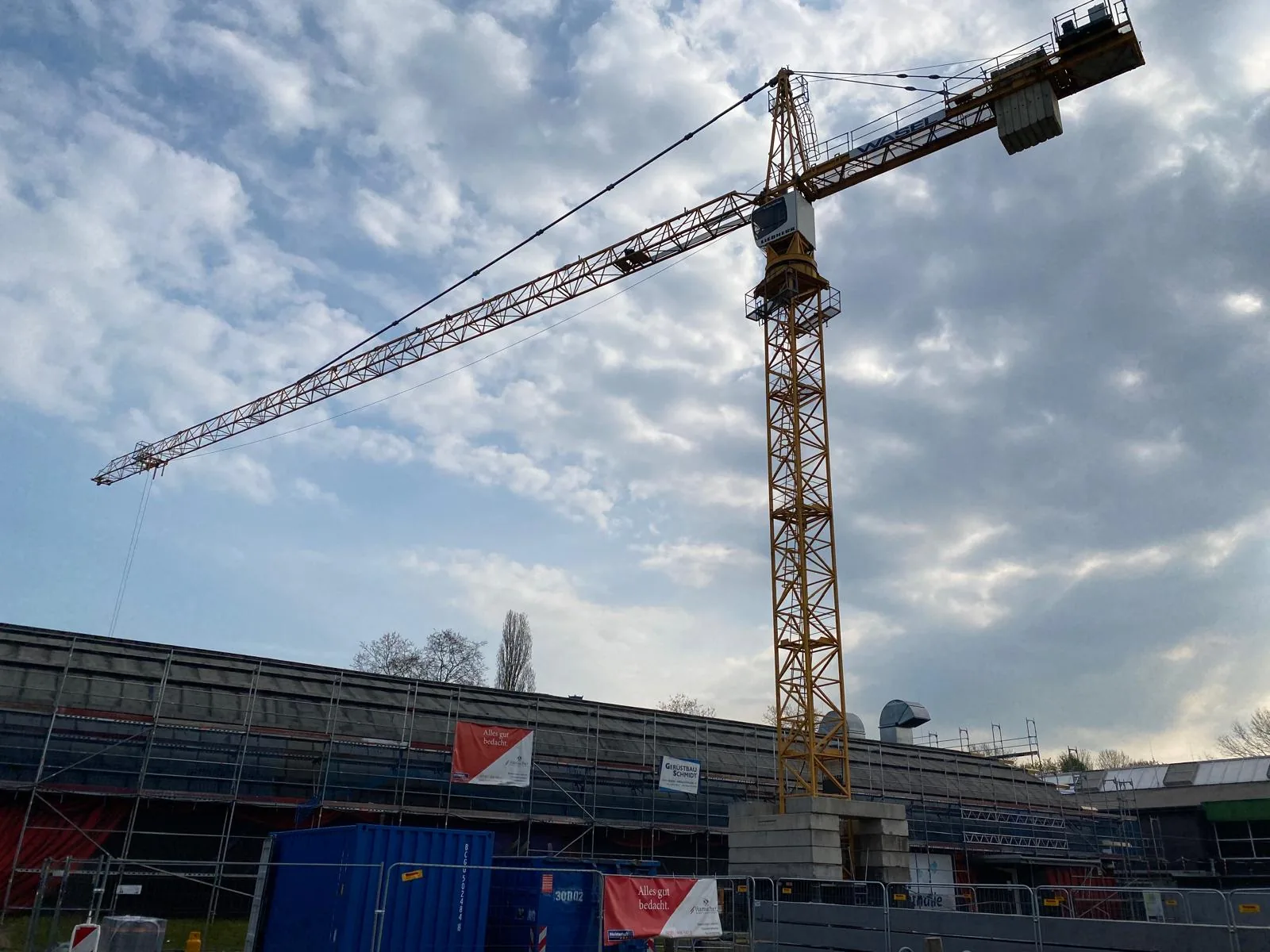 Turmdrehkran im Einsatz über einer großen Dachfläche, Hamacher Bedachungen